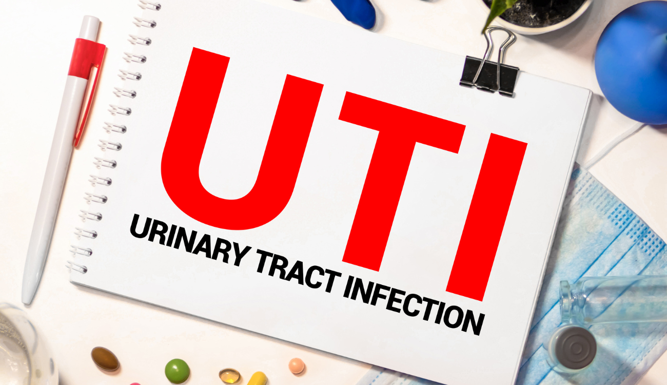 UTI Urinary Tract Infection written in notebook on white table