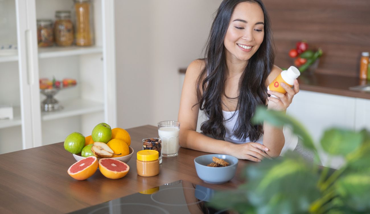 Young woman taking a nutritional supplement